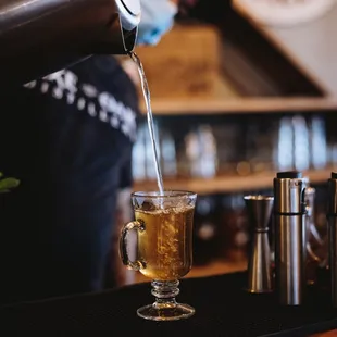 a bartender pouring a drink