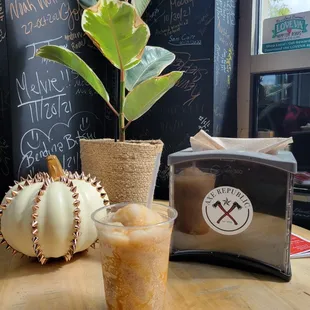 a cup of iced coffee and a pumpkin