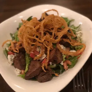 a plate of salad with onions