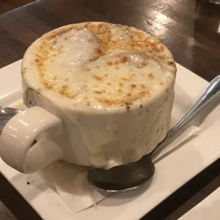 a cup of coffee on a plate with a spoon