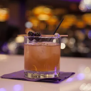 a cocktail with a garnish garnish