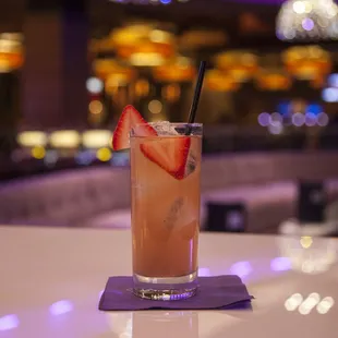 a drink with strawberries in a tall glass