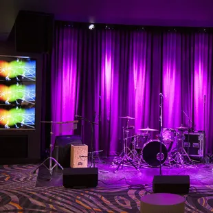a stage with a drum set and a television