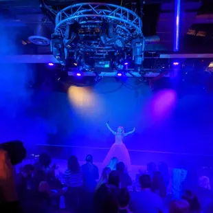 a woman in a white dress on stage