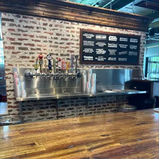 a bar counter with a menu on the wall