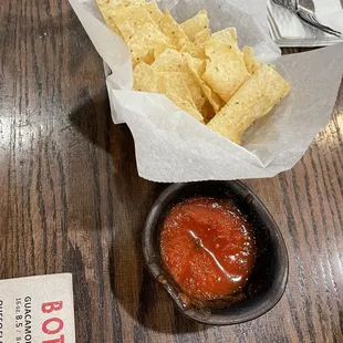 a bowl of chips and a bowl of salsa