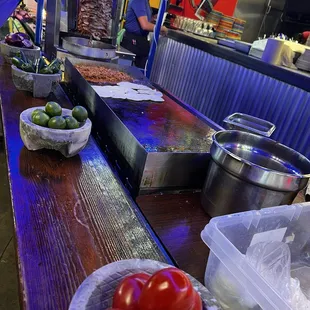 Fresh pastor and heating the tortillas.