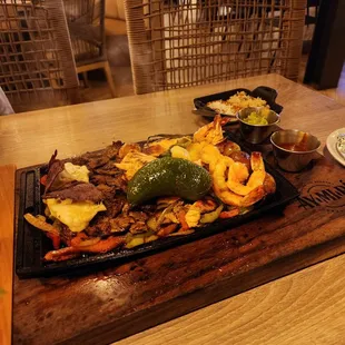 Fajitas trio, well cooked and delicious. Served with guacamole and a spicy sauce.
