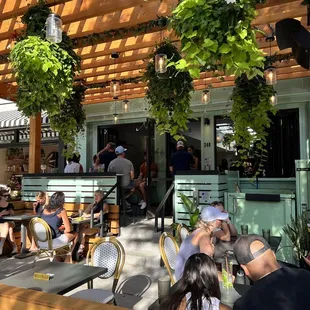 a group of people sitting outside a restaurant