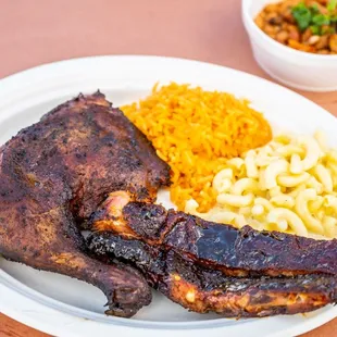 a plate of ribs, macaroni and cheese