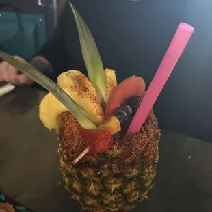 a pineapple with fruit in it