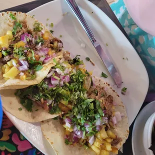 Carnitas tacos with pineapple,  red onion and cilantro.  Yum!