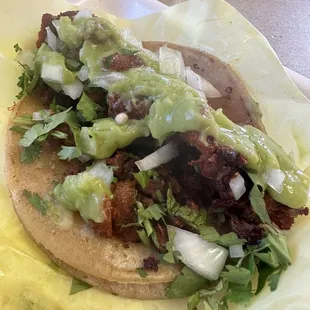 a taco with lettuce and meat
