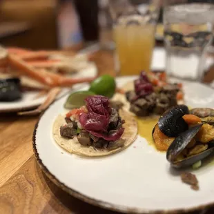 Carne Asada Tacos, mussels, snow crab legs