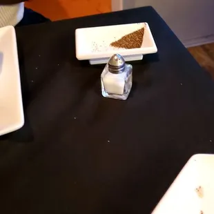 Salt and pepper in a dish