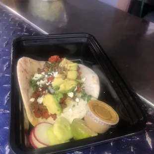 Al pastor taco on flour tortillas onion cilantro wasp fresco and avocado slices