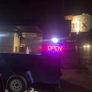 a neon open sign in the dark