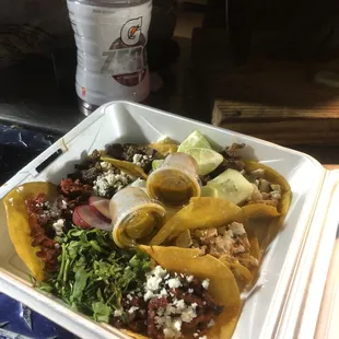 a plate of tacos and a bottle of water