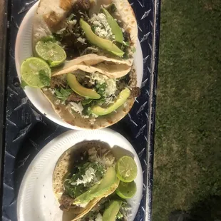 two plates of tacos on a table