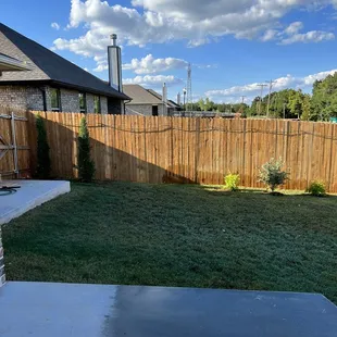 a back yard with a wooden fence