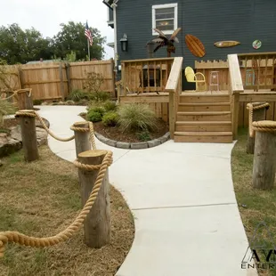a backyard with a roped walkway