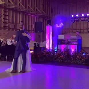 a bride and groom dancing at a wedding reception