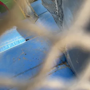 Inside of bounce house full of dirt and filthy.