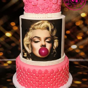 a pink cake with a picture of marilyn monroe