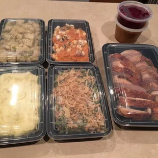 Thanksgiving dinner stuffing, sweet potato casserole, mashed potatoes, green bean casserole, sliced turkey breast, gravy, cranberry sauce