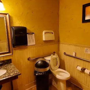 a man taking a picture of a bathroom