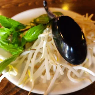 a plate of noodles and a spoon