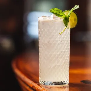 a closeup of a tall glass with a lime garnish