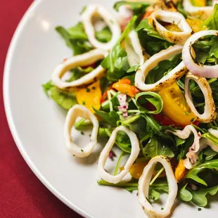 a white plate with a salad on it
