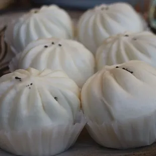 six steamed dumplings on a plate