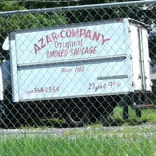 a truck behind a chain link fence