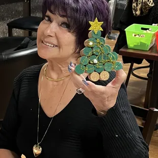 a woman holding a christmas tree