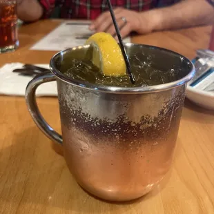 a drink in a copper mug