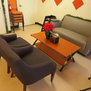 a living room with a couch, chair, and coffee table