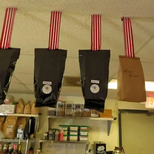 three bags of coffee hanging from the ceiling