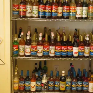 a shelf full of bottles and sauces