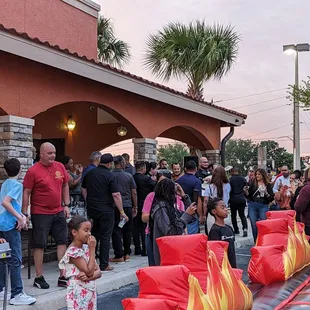 Outside and people waiting for the mechanical bull ride
