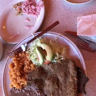 The remains of an incredible pork papusa (top) and a steak milanesa plate. Highly recommend!