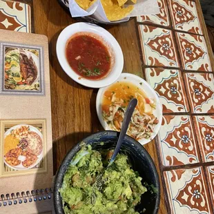 a table with chips and guacamole