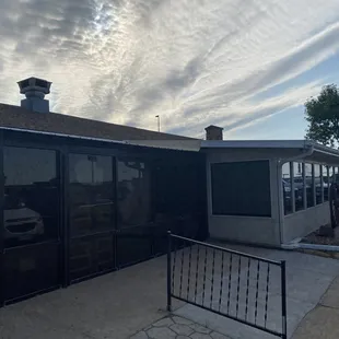 the outside of a building with a car parked in front of it