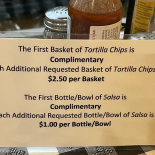 a sign stating the first basket of tortilla chips is $ 2 50 per basket