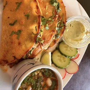Birria, with consume, AMAZING spicy green sauce.