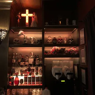 a shelf of liquor and candles