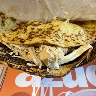 a chicken sandwich in a paper bag