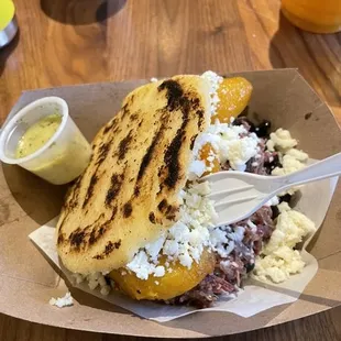 The panellon arepa. It's on the premium menu. You don't need a side. It's a ton of food.