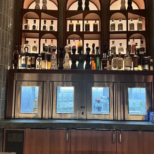 a bar with a lot of bottles on the shelves
